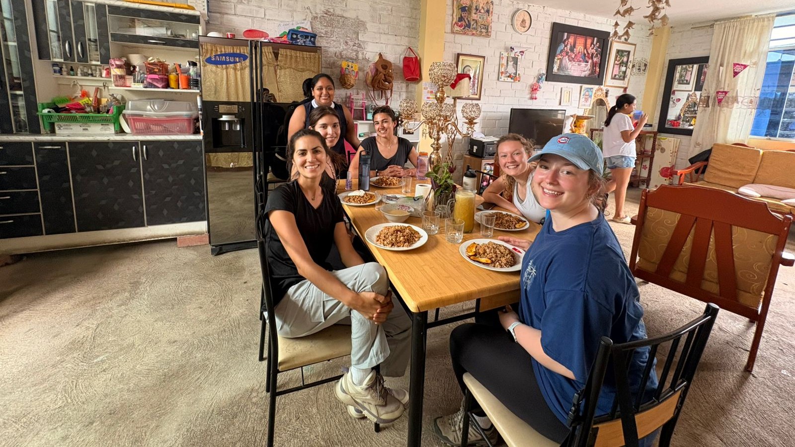 Gannon Scholars sit with community members at a table